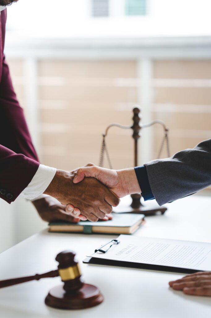 Portrait of lawyer in law office hand shake giving advice and advice on lawsuit consulting concept