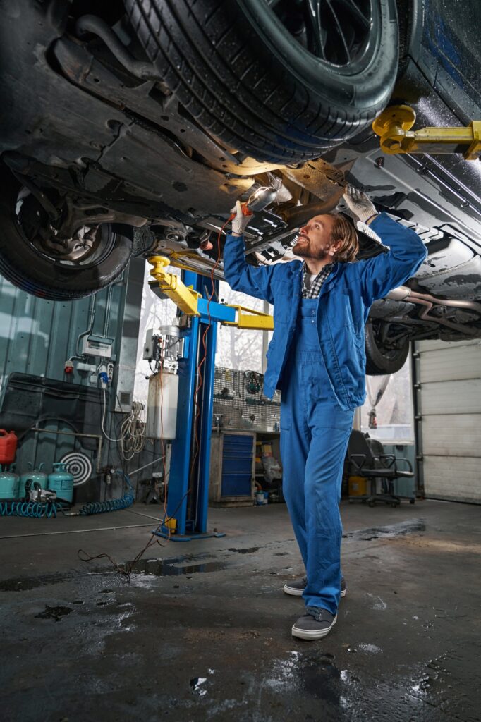 Mechanic holding lamp and performing machine diagnostics