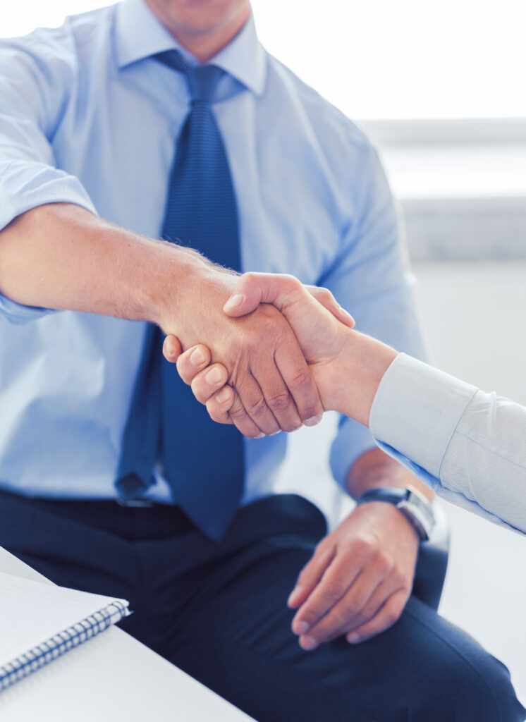 Businesss And Office Concept - Two Businessmen Shaking Hands In Office